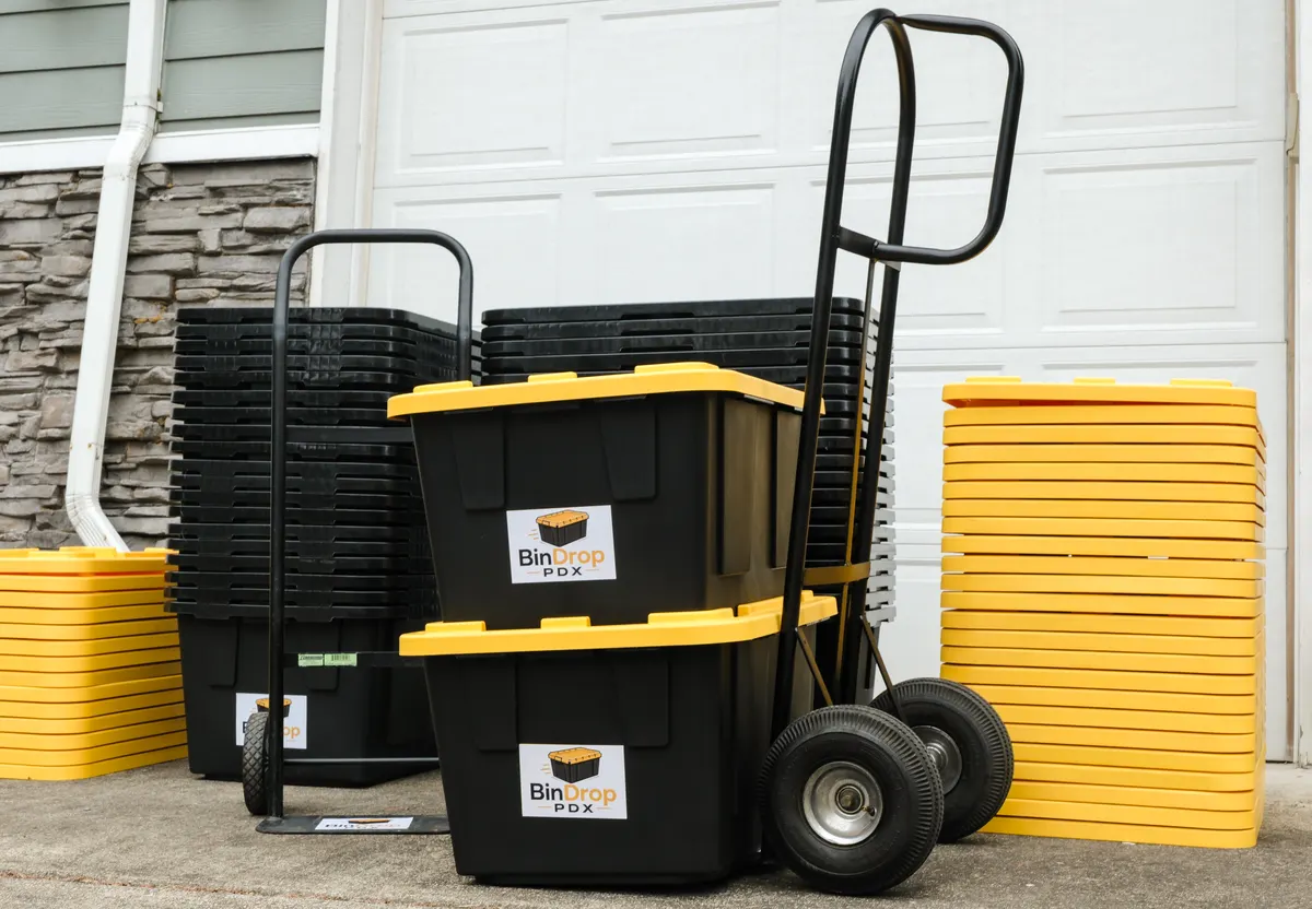 BinDrop PDX moving bins, lids, and hand trucks ready outside a garage